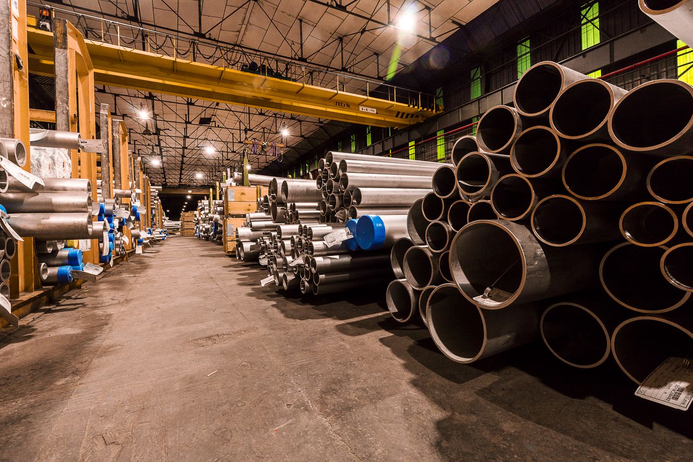 Stacks of finished steel pipe inside the Pabna plant